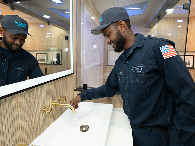 plumber repairing bathroom drain