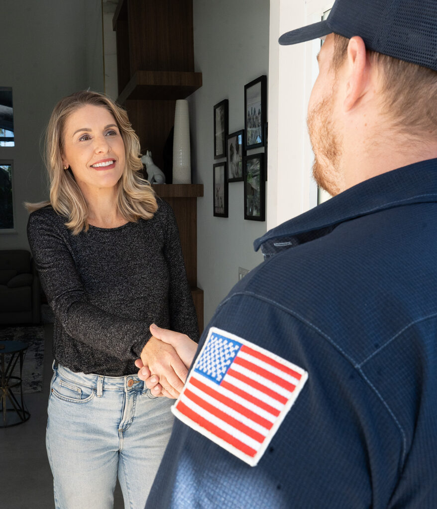 A woman greets Paramount's plumber at her doorway