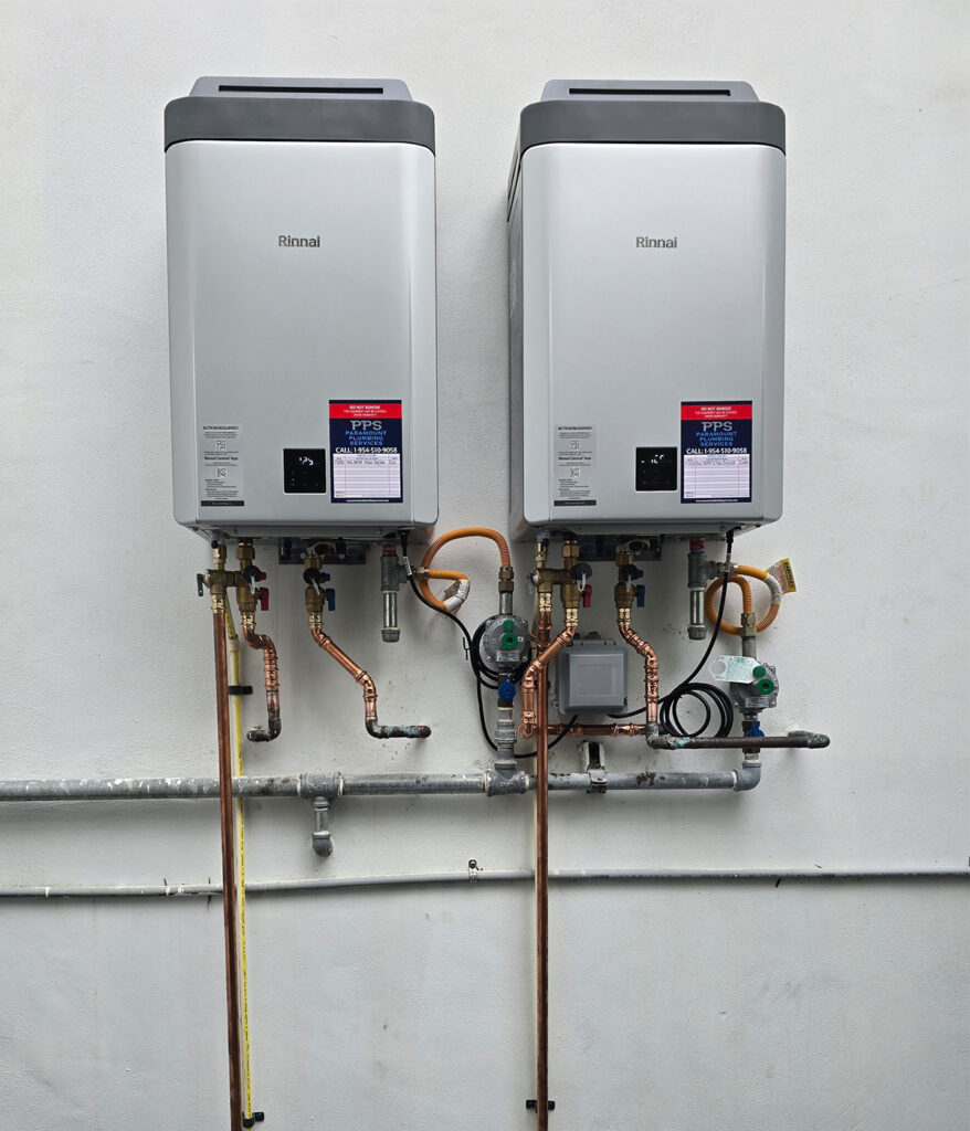Two Rinnai tankless water heaters installed side by side on exterior wall