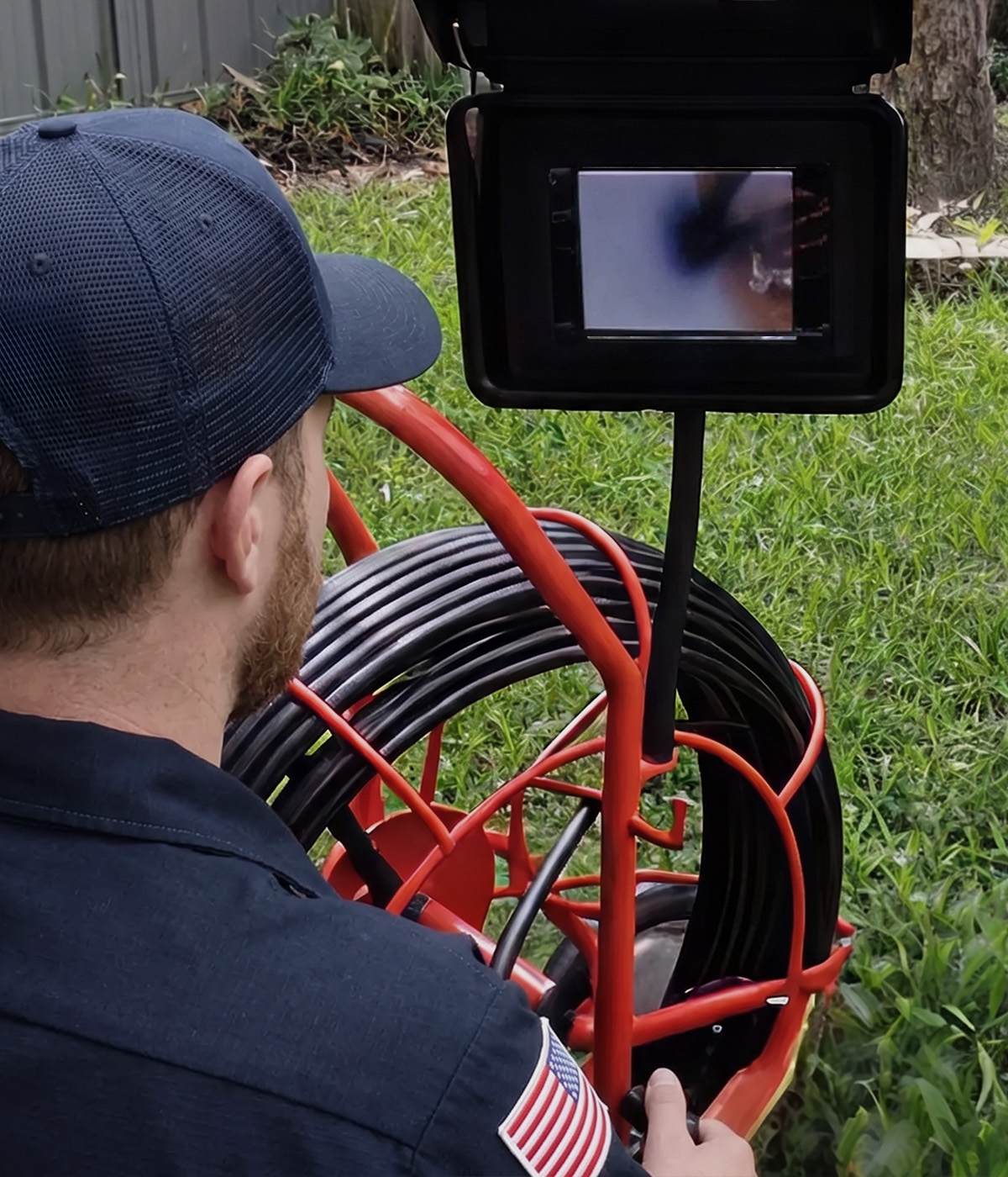 Paramount's plumber conducting a sewer line camera inspection, viewing live pipe footage on a monitor
